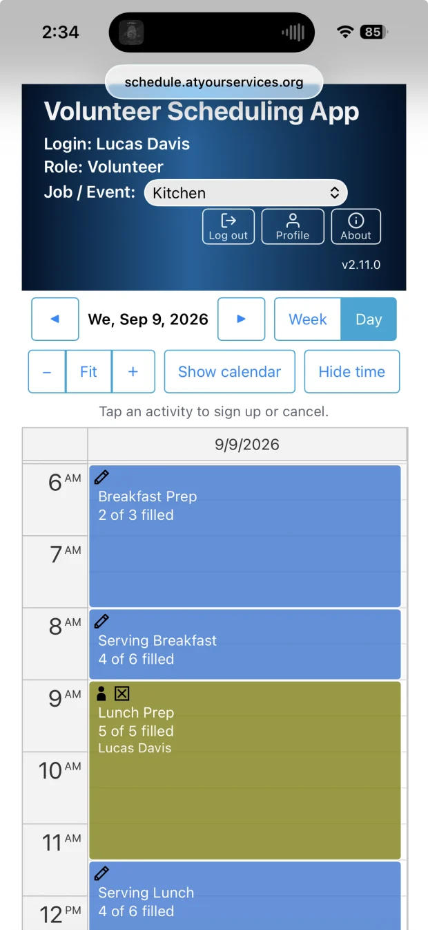 A volunteer's phone showing one day in the Kitchen: Breakfast Prep 2 of 3 filled, Serving Breakfast 4 of 6, Lunch Prep full at 5 of 5 with their own name on it, Serving Lunch 4 of 6